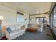 Cozy sunroom with comfortable seating, large windows for natural light, and serene views at 772 Imperial Dr, North Port, FL 34287