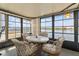 Bright sunroom with picturesque lake views, featuring a dining table and comfortable seating arrangements at 772 Imperial Dr, North Port, FL 34287