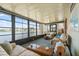 Bright sunroom with large windows offering scenic lake views, comfortable seating, and serene ambiance at 772 Imperial Dr, North Port, FL 34287