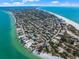 Breathtaking aerial view of a coastal neighborhood with stunning beach access and vibrant turquoise waters at 821 S Bay Blvd, Anna Maria, FL 34216