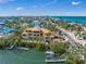 Aerial view of the waterfront home with dock under construction with coastal views and in a desirable community at 821 S Bay Blvd, Anna Maria, FL 34216