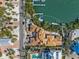 Aerial view of the new construction home with dock under construction and surrounded by trees and waterfront views at 821 S Bay Blvd, Anna Maria, FL 34216