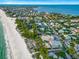 An aerial view of luxurious waterfront homes nestled along a pristine beach, offering the ultimate coastal living experience at 821 S Bay Blvd, Anna Maria, FL 34216