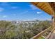Balcony view showcases the bay and surrounding trees from an elevated perspective at 821 S Bay Blvd, Anna Maria, FL 34216