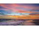 Colorful sunset over the ocean with waves gently rolling onto the sandy beach at 821 S Bay Blvd, Anna Maria, FL 34216