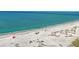 Aerial view of a pristine white sandy beach with clear turquoise water, inviting relaxation and scenic beauty at 821 S Bay Blvd, Anna Maria, FL 34216