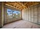 Spacious unfinished bedroom with wood beam ceiling and large picture window at 821 S Bay Blvd, Anna Maria, FL 34216