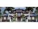 Stunning new construction, multi-story home featuring a stone facade, modern architectural design, and lush tropical landscaping at 821 S Bay Blvd, Anna Maria, FL 34216