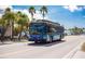The Anna Maria Island free trolley travels down a picturesque street lined with palm trees at 821 S Bay Blvd, Anna Maria, FL 34216