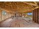 Spacious great room under construction, featuring exposed wood beams and a view of the outside at 821 S Bay Blvd, Anna Maria, FL 34216