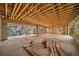 Unfinished living room with wood beam ceiling and large window overlooking the water at 821 S Bay Blvd, Anna Maria, FL 34216