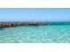 Crystal clear ocean view with pelicans perched on a weathered wooden structure at 821 S Bay Blvd, Anna Maria, FL 34216