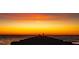 Stunning sunset view from a pier with two people fishing at the end, silhouetted against the vibrant sky at 821 S Bay Blvd, Anna Maria, FL 34216