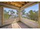 View of unfinished sun room showcasing a view of the bay framed by trees under a blue sky at 821 S Bay Blvd, Anna Maria, FL 34216