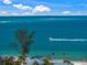 Beautiful waterfront view capturing the sea, sky, and a passing boat, with a glimpse of nearby beachfront homes at 821 S Bay Blvd, Anna Maria, FL 34216