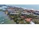 Overhead view showcases condos nestled near the beach, docks, and other buildings at 8625 Midnight Pass Rd # 305B, Sarasota, FL 34242