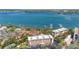 Stunning aerial view of the condo complex with water views, boat docks and manicured grounds at 8625 Midnight Pass Rd # 305B, Siesta Key, FL 34242