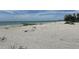 Expansive sandy beach with calm turquoise waters, offering a serene and relaxing waterfront experience at 8625 Midnight Pass Rd # 305B, Sarasota, FL 34242