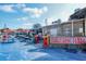 Seafood restaurant exterior with outdoor seating, vibrant signage, and blue-painted ground at 8625 Midnight Pass Rd # 305B, Siesta Key, FL 34242