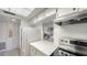 Galley kitchen has a bright ambiance, modern range, and a pass-through to the living area at 8625 Midnight Pass Rd # 305B, Siesta Key, FL 34242