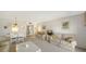 Bright living room featuring striped sofas, white walls, and an adjacent dining area at 8625 Midnight Pass Rd # 305B, Sarasota, FL 34242