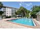 Community swimming pool surrounded by lounge chairs and well-maintained landscaping at 8625 Midnight Pass Rd # 305B, Sarasota, FL 34242