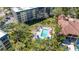 Stunning aerial view of pool and landscaping surrounding the condos at 8625 Midnight Pass Rd # 305B, Siesta Key, FL 34242