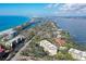 Stunning aerial view of the condo complex near both the beach and the bay with lush landscaping at 8625 Midnight Pass Rd # 305B, Siesta Key, FL 34242