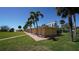 Beach bath houses located on manicured lawn with palm trees, perfect for relaxing beach days at 8625 Midnight Pass Rd # 305B, Siesta Key, FL 34242