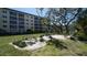 Well-maintained grounds with beautiful landscaping, seating, and mature trees at 8625 Midnight Pass Rd # 305B, Siesta Key, FL 34242