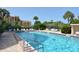 Community pool with lounge chairs for relaxing by the water at 8625 Midnight Pass Rd # 305B, Siesta Key, FL 34242