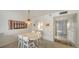 Cozy dining area with a round table, four chairs, and a decorative light fixture, adjacent to the kitchen at 8625 Midnight Pass Rd # 305B, Siesta Key, FL 34242