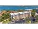 Beautiful condo building with lush landscaping and ample parking, near bay and other residential buildings at 8625 Midnight Pass Rd # 305B, Siesta Key, FL 34242