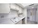 Bright kitchen features classic white cabinetry, laminate countertops, and essential appliances at 8625 Midnight Pass Rd # 305B, Siesta Key, FL 34242