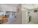 Bright living room showing the kitchen, sofas, dining table, and sliding glass doors to the balcony at 8625 Midnight Pass Rd # 305B, Siesta Key, FL 34242