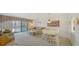 Bright living room featuring a seating area, dining area, and a sliding glass door to the outside at 8625 Midnight Pass Rd # 305B, Siesta Key, FL 34242