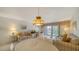 Bright living room featuring sofas, a dining table, and a sliding glass door to the outside at 8625 Midnight Pass Rd # 305B, Siesta Key, FL 34242