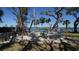 Community outdoor lounge with picnic tables, chairs, and barbecue grills at 8625 Midnight Pass Rd # 305B, Siesta Key, FL 34242