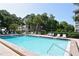 Bright pool and lounge area surrounded by green trees offer a peaceful atmosphere at 8625 Midnight Pass Rd # 305B, Siesta Key, FL 34242