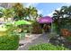 Restaurant entrance with outdoor seating, lush greenery, and a colorful, inviting atmosphere at 8625 Midnight Pass Rd # 305B, Siesta Key, FL 34242