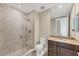A bathroom with a glass-enclosed shower and granite countertop vanity at 10520 Boardwalk Loop # 503, Bradenton, FL 34202