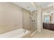 Modern bathroom featuring a soaking tub and glass shower with tiled walls and floors, plus updated vanity at 10520 Boardwalk Loop # 503, Bradenton, FL 34202