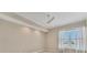 A bedroom with a ceiling fan and large window providing natural light at 10520 Boardwalk Loop # 503, Bradenton, FL 34202