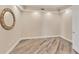 A bedroom with an ornate mirror, wood-look tile flooring, and neutral walls at 10520 Boardwalk Loop # 503, Bradenton, FL 34202