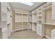 Walk-in closet featuring an organized shelving system and rods for optimal storage and organization at 10520 Boardwalk Loop # 503, Bradenton, FL 34202