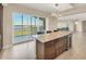 Kitchen island with seating, wine cooler and granite countertop with easy access to the lanai at 10520 Boardwalk Loop # 503, Bradenton, FL 34202