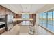 Modern kitchen featuring stainless steel appliances, granite counters, and a center island at 10520 Boardwalk Loop # 503, Bradenton, FL 34202