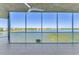 Spacious lanai with tiled floor offering panoramic lake views and a ceiling fan at 10520 Boardwalk Loop # 503, Bradenton, FL 34202