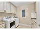 A laundry room featuring a washing machine, dryer, and storage at 10520 Boardwalk Loop # 503, Bradenton, FL 34202