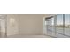Neutral living room with large sliding doors accessing balcony offering views of the surrounding area at 10520 Boardwalk Loop # 503, Bradenton, FL 34202